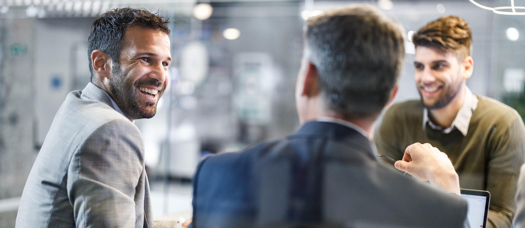 Happy businessmen having a discussion on a meeting in the office.